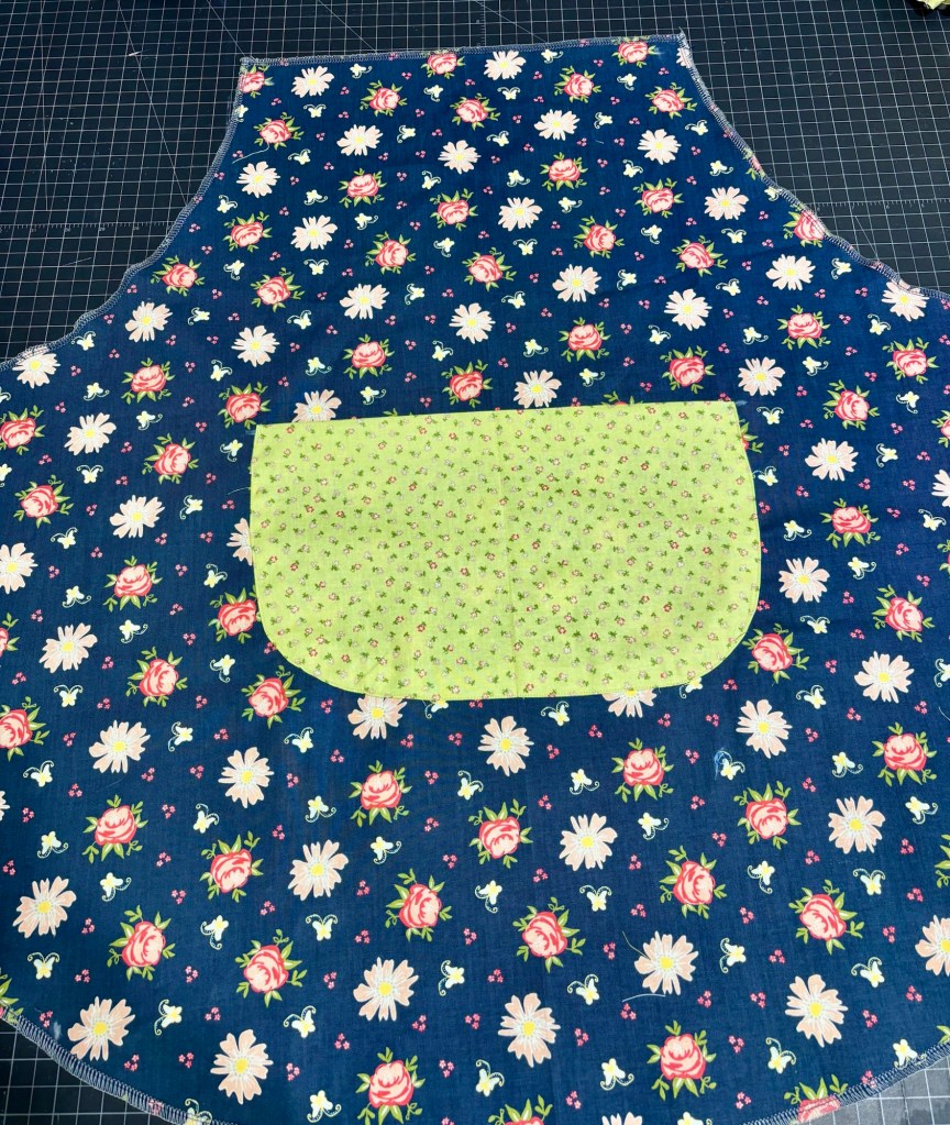 Apron sewed to pocket