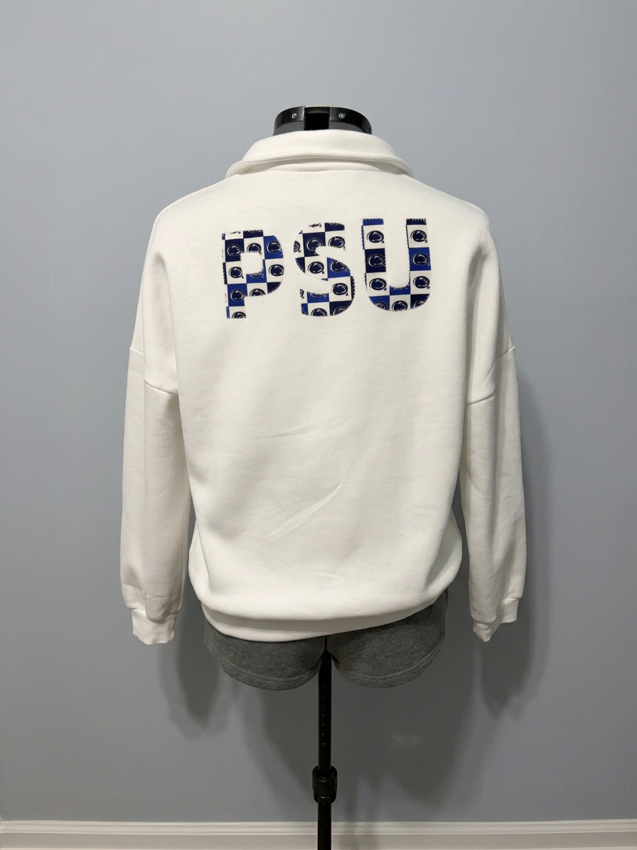 img_0892 Back view of a white sweatshirt featuring the letters 'PSU' in a blue and white patterned design.